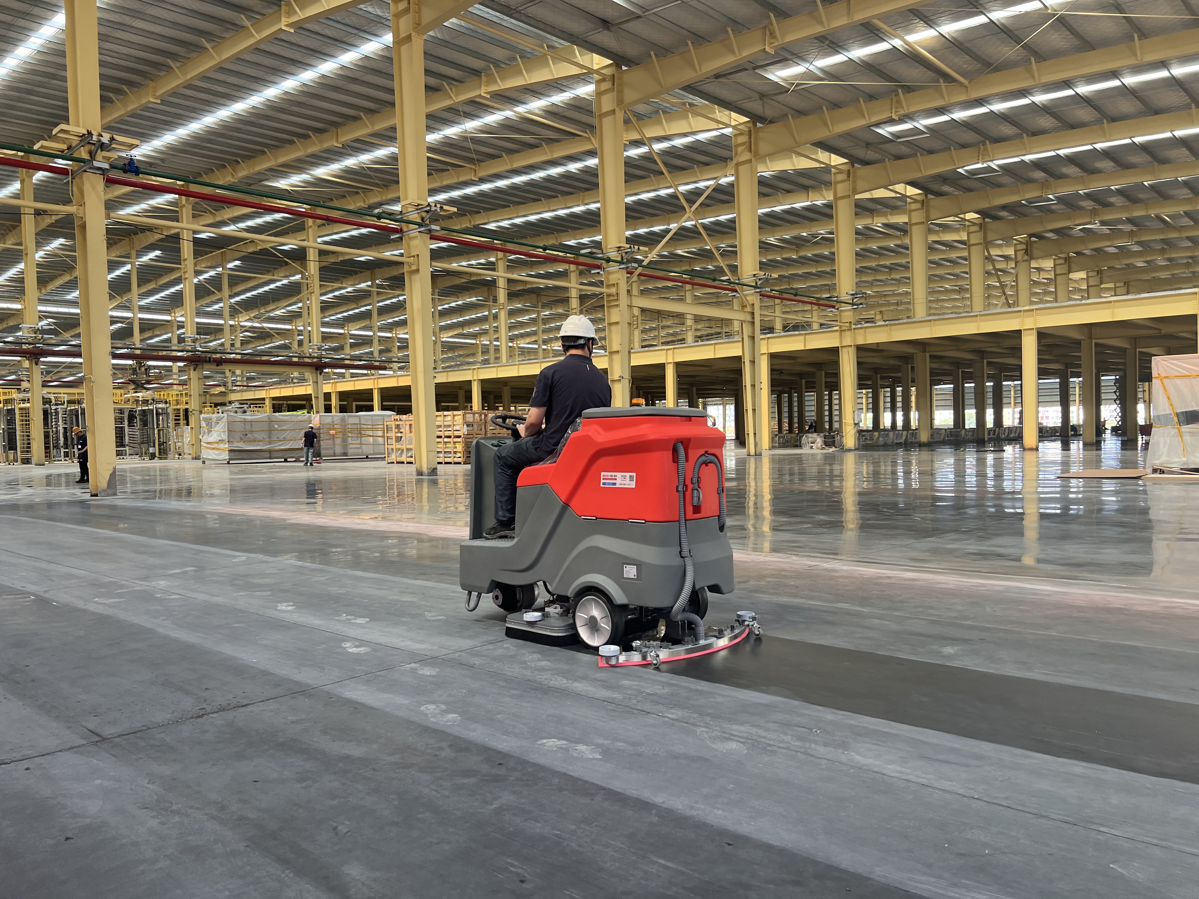 Siben X8 industrial floor scrubber cleaning a large factory floor to a dry finish protecting epoxy coating and controlling dust in a battery-grade facility
